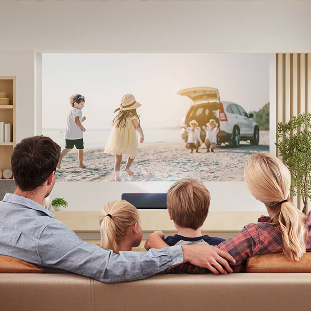 Family watching a bright, high-resolution movie projection in a sunlit living room — ultra short throw projector delivering vivid images in well-lit home environments